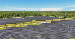 Ilmakuvaa aurinkovoimapuistosta, jossa näkyy aurinkopaneeleja riveissä. 